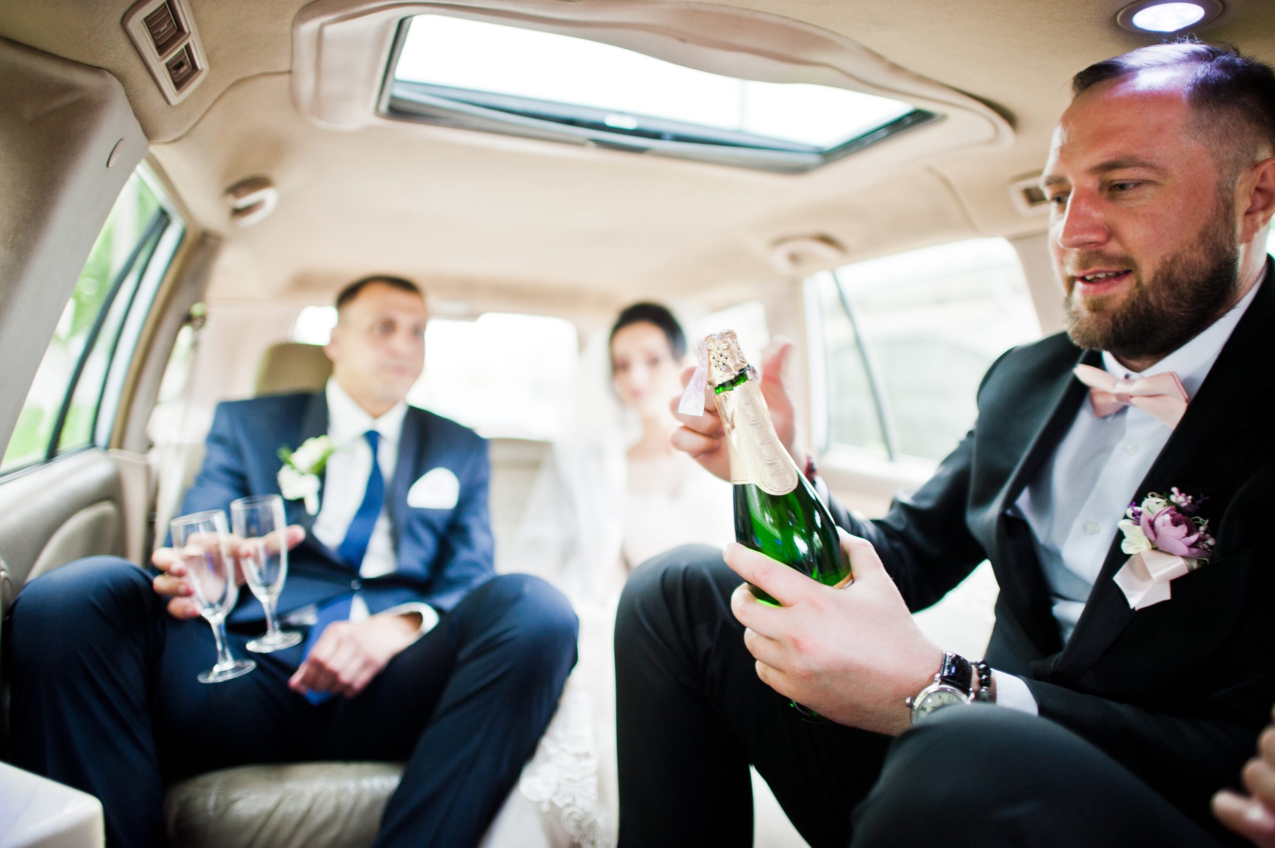 Bride and Groomsman celebrating in wedding limo Toronto