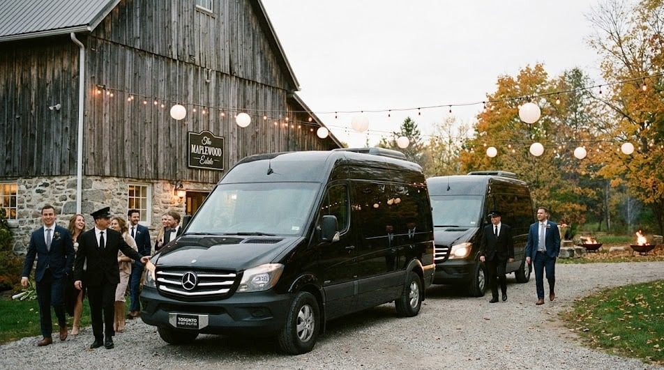 Two black Mercedes Sprinters at a Vaughan estate wedding under string lights