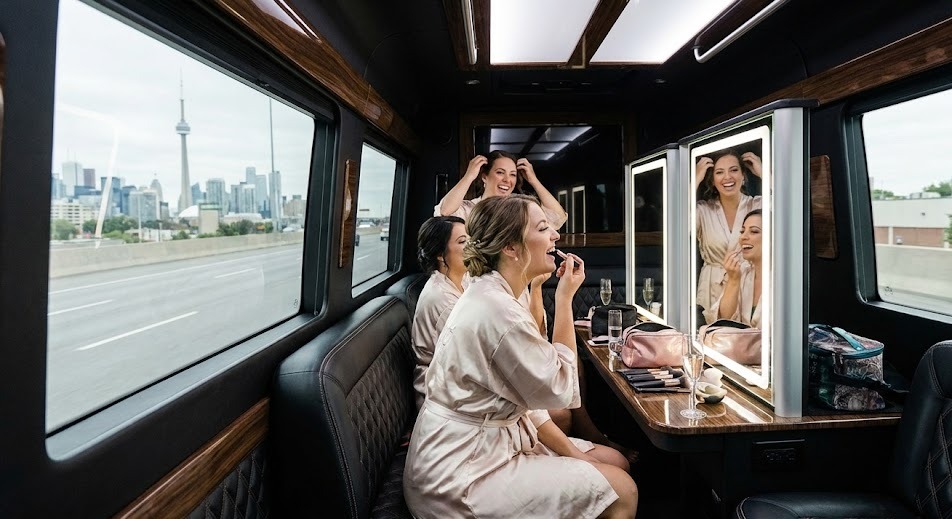 Bridal party getting ready inside a black VIP Sprinter cabin en route to a Muskoka wedding