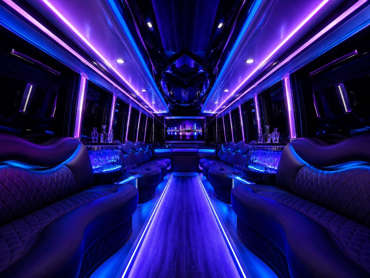 Empty blue-lit party van lounge interior with curved leather seating