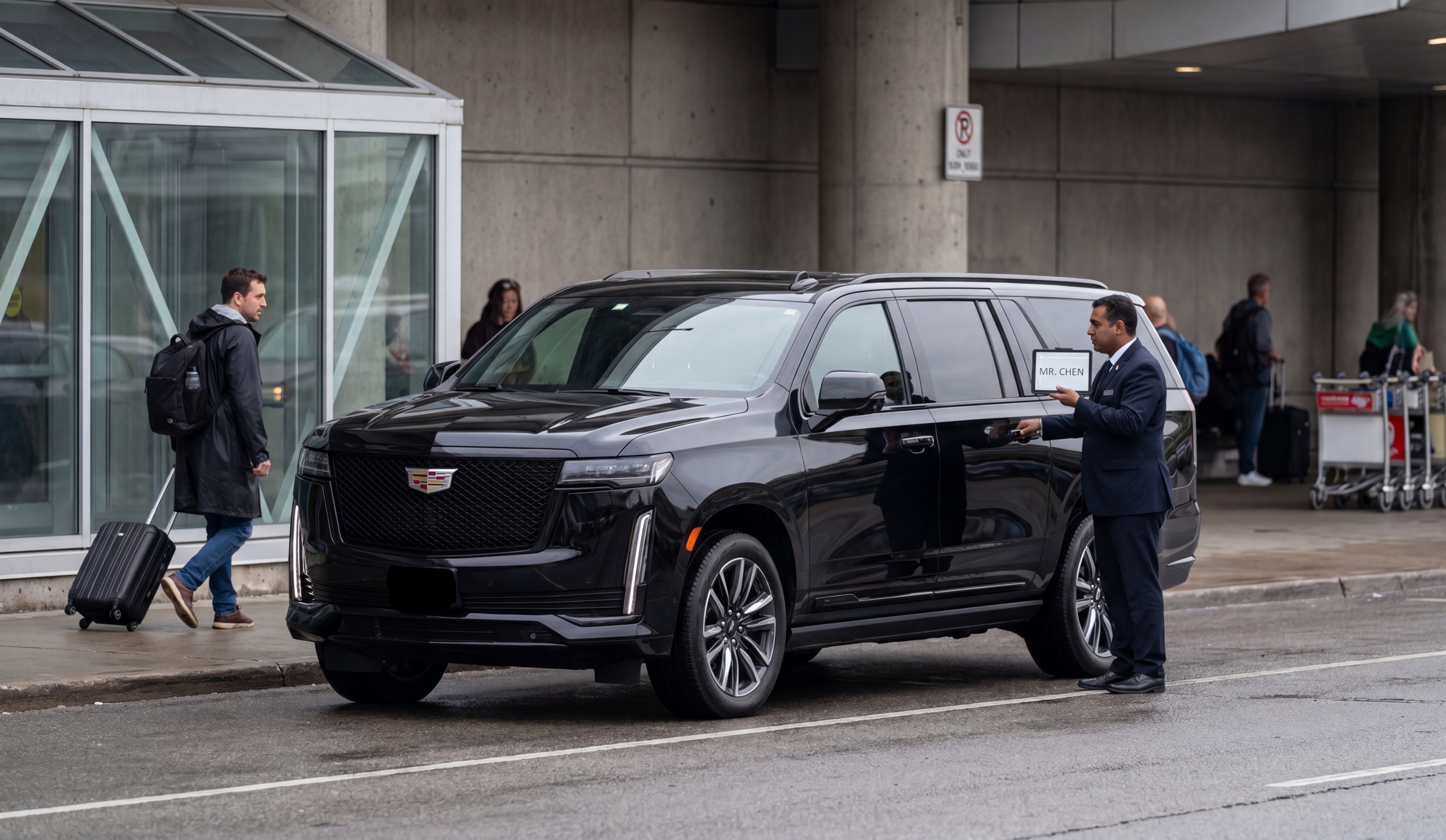 Escalade at Pearson Airport with driver holding TIFF nameplate
