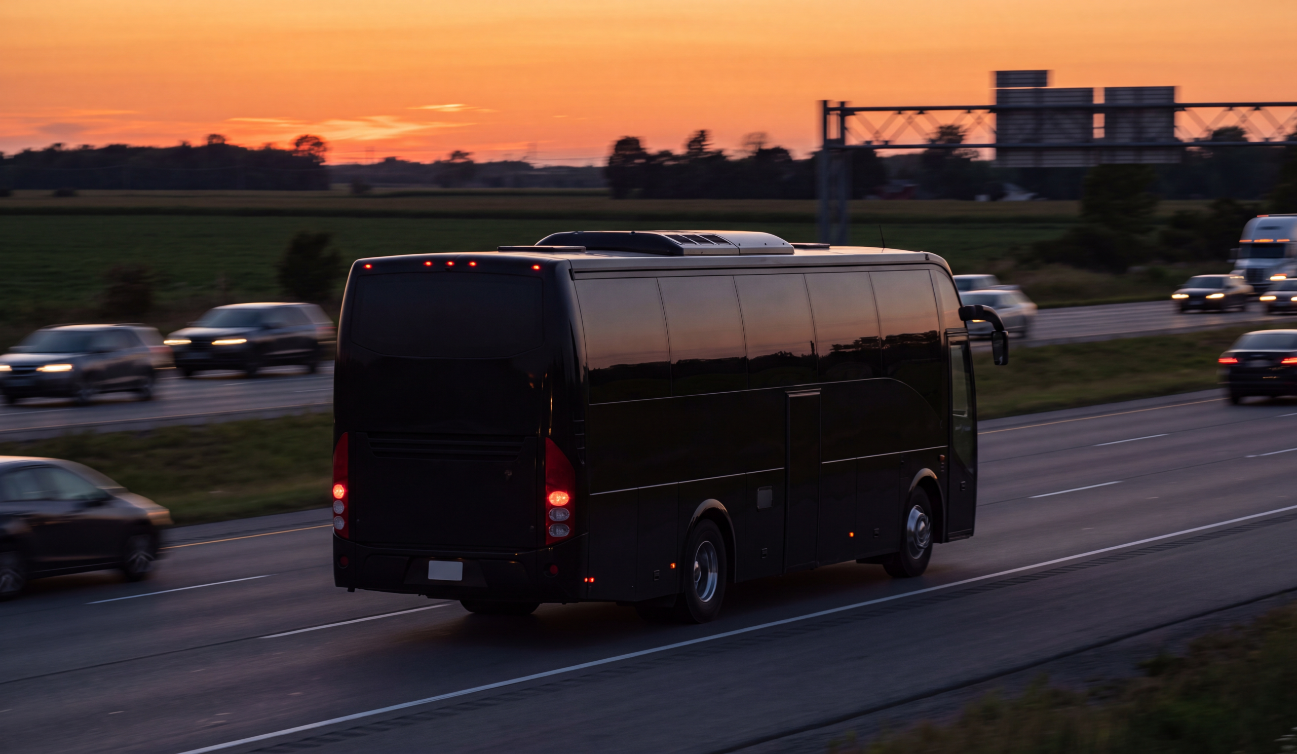 Kitchener-Waterloo Concert Group Shuttle 1 Black shuttle on Highway 401 eastbound toward Toronto at dusk