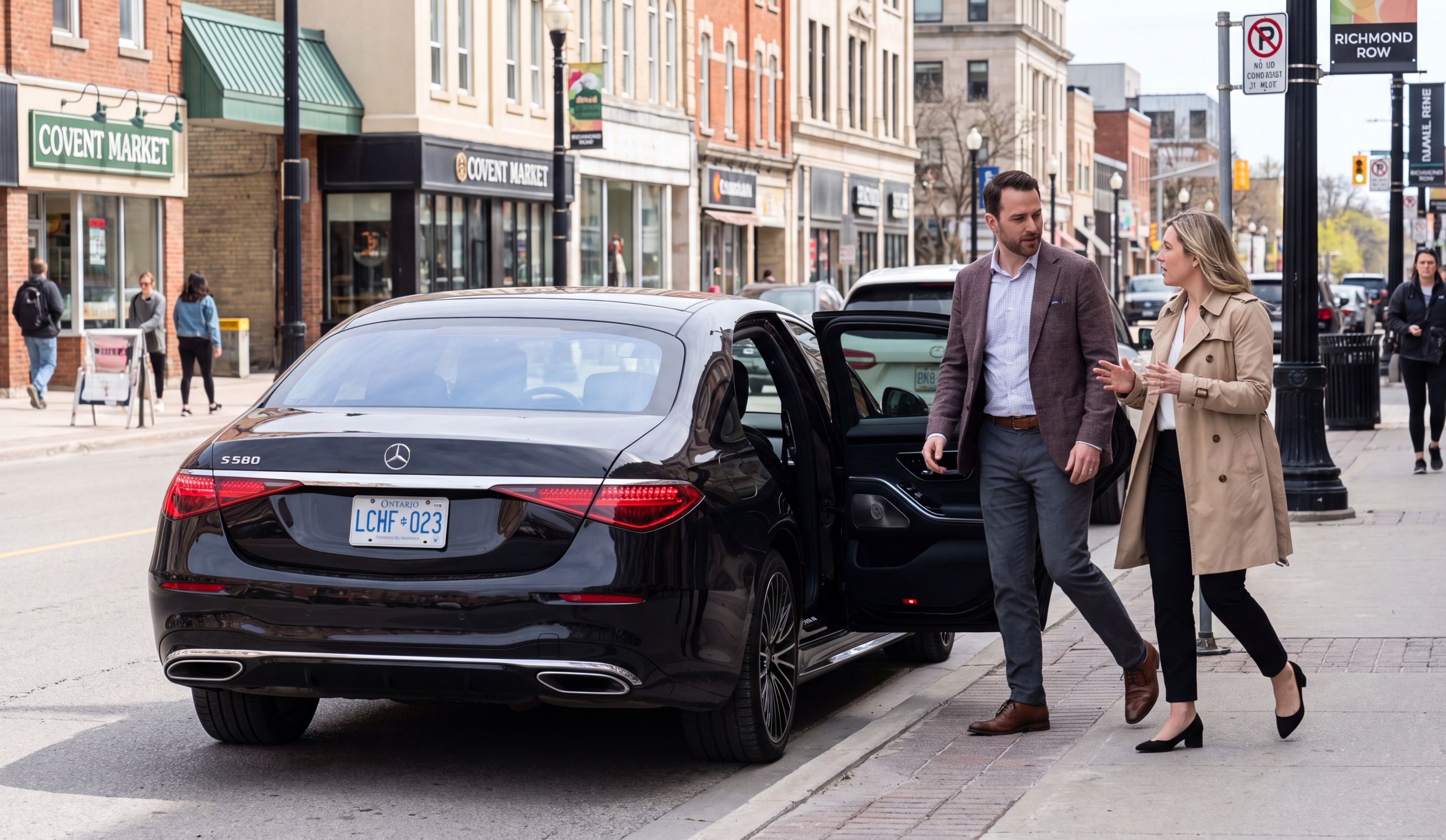 Black Mercedes-Benz S580 sedan pulled to the kerb along Dundas Place in downtown London Ontario